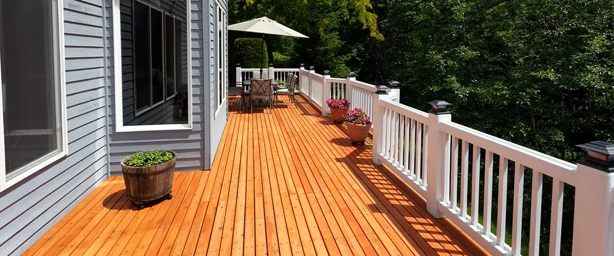 Cedar decking installation with white railing