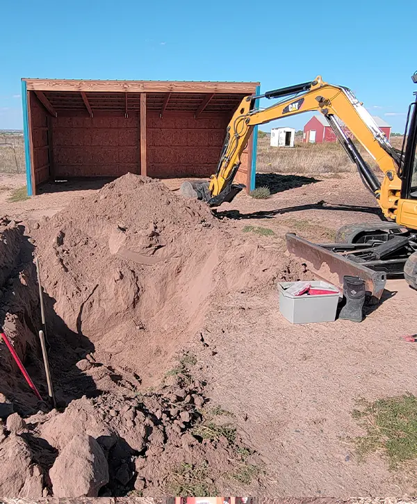 Man Excavating in Valley Ranch With Cat Excavator